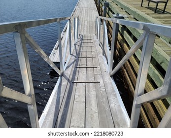 A Top Down View Of A Wooden Ramp Leading To A Boat Launch Area.