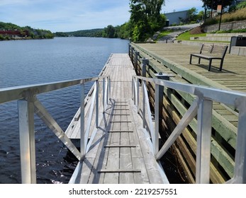 A Top Down View Of A Wooden Ramp Leading To A Boat Launch Area.