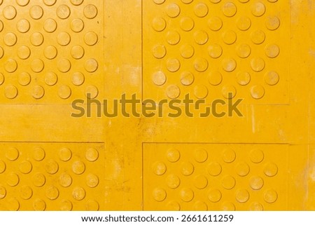 A top down view of yellow truncated domes, as a background.