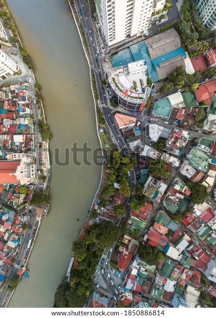 Top drone view of\
the Pasig River separating the cities of Mandaluyong and Makati,\
both part of Metro Manila.