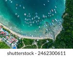 Top drone view of a traditional philippine boats on the surface of the azure water in the lagoon. Seascape with blue bay and boats view from above. El Nido, Palawan, Philippines.