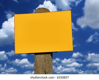 top of empty sign post against summer sky with cumulus clouds