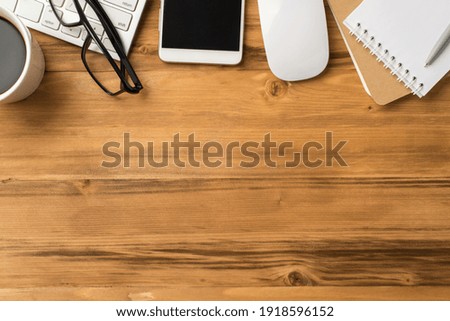 Top flat lay layout close up view photo image of copybooks cellphone eyewear mug of beverage on loft light brown background
