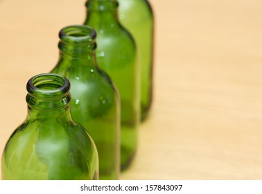 Top of four green bottles in a row