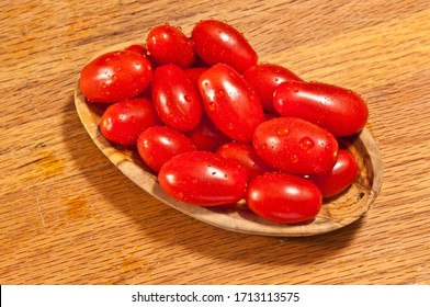 Top, Front View, Close Distance Of,  Freshly Picked, Ripe, Local, Cherry Tomatoes In A Rare, Wood Bowl, On A Maple Wood Cutting Board