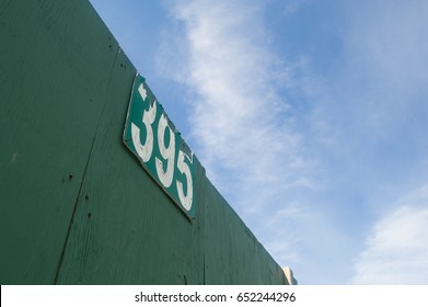 Top Of A Green Baseball Field Wall With A Distance Marker