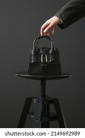 Top handle mini black bag made in textured, resistant leather. Studio shot on black background. - Shutterstock ID 2149692989