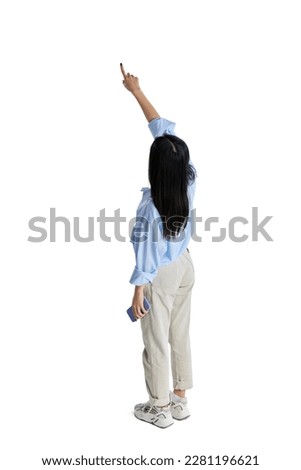 Top isometric back view of young girl in formal wear, shirt pointing with finger on illusion screen isolated over white studio background. Concept of business, education. lifestyle. Copy space for ad