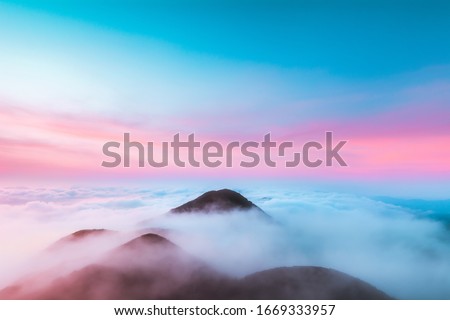 Top of Khao Lon Hills wrapped with morning cloud before sunrise from Phatthalung, Southern Province of Thailand