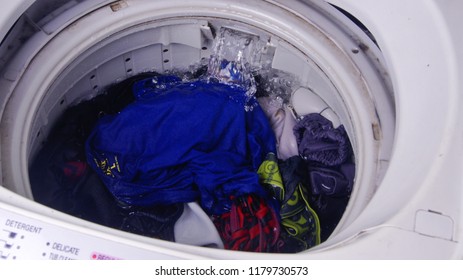 Top Load Washing Machine With Clothes Loaded To Be Cleaned