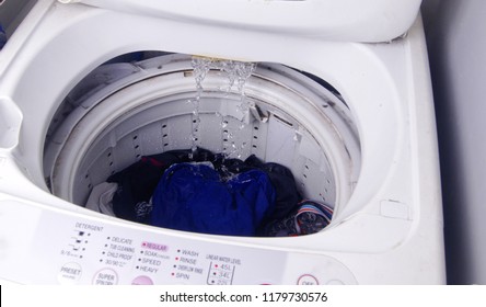 Top Load Washing Machine With Clothes Loaded To Be Cleaned