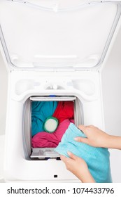 Top Loader Washing Machine Loaded With Colorful Clothes From Above.