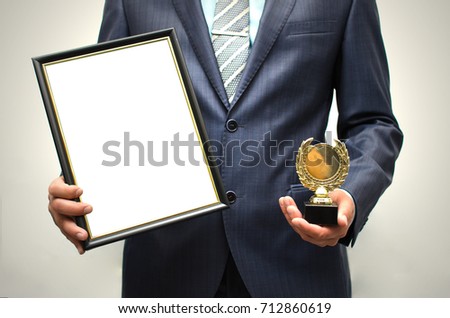 Top manager award mockup. Best office employee award. Business man holding empty blank photo frame (gratitude letter) in one hand and gold medal in another one. Gratitude concept. Grateful letter.