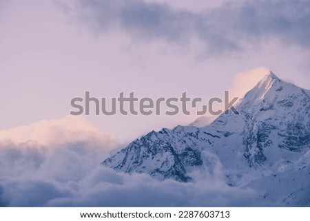 the top of Mount Everest covered in clouds