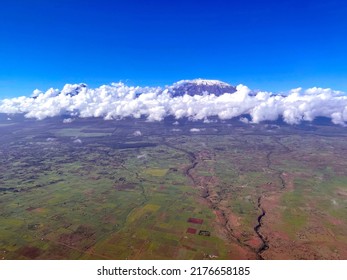 The Top Of Mount Kilimanjaro Is Shrouded In White Clouds. Bird's Eye View