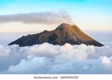 Top of Mount Merapi Summit Volcano above the clouds viewed from Mount Merbabu
