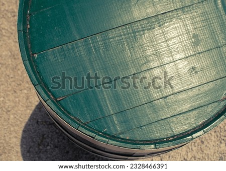 Top of old wooden green barrell - close up with wood and paint, space for copy or product