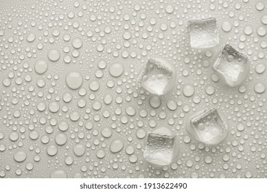 Top overhead above view photo image of ice cubes with rain drops on grey backdrop
