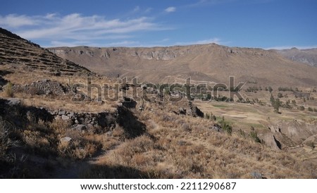 From the top of a Peruvian mountain, a breathtaking panoramic view of the Uyu Uyu region unfolds. Surrounded by ancient ruins, deep valleys, and rugged peaks, the landscape tells the story of past