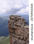 the top of a rocky cliff, a rocky outcropping, folded by a layered limestone, top-down view