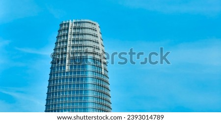 Top of Salesforce Tower on cloudy blue sky day aerial in San Francisco, CA