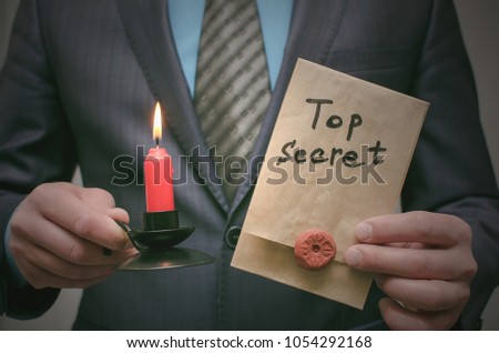 Top secret concept. Top secret documents or message in businessman hands. Confidential dossier information. Super important information.