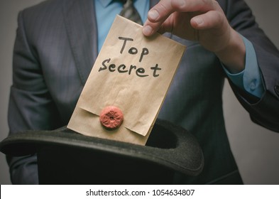 Top Secret Concept. Open The Secret. Business Man Takes Out Secret Documents From His Hat. Confidential Dossier Information. Super Important Information.