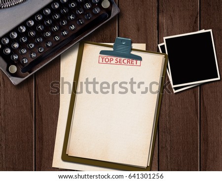 Top secret document on old wooden table.