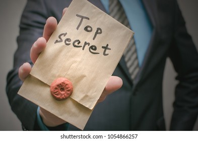 Top Secret Documents Presentation Concept. Top Secret Message In Detective Spy Agent Hands. Confidential Dossier Information. Super Important Information.