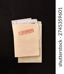 Top secret file folder with documents inside on dark background. Concept of confidential information, data leak, corporate secrets, investigation and security breach.