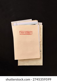 Top secret file folder with documents inside on dark background. Concept of confidential information, data leak, corporate secrets, investigation and security breach.