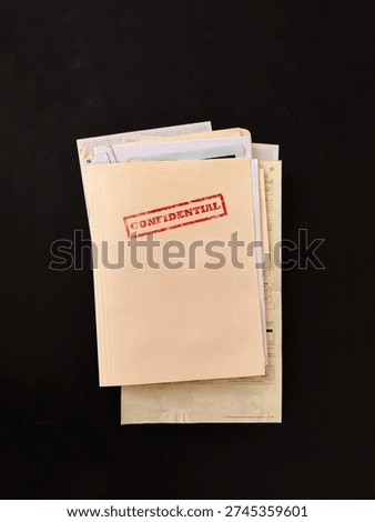 Top secret file folder with documents inside on dark background. Concept of confidential information, data leak, corporate secrets, investigation and security breach.
