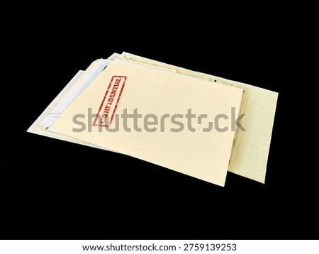 Top secret file folder with documents inside on dark background. Concept of confidential information, data leak, corporate secrets, investigation and security breach.