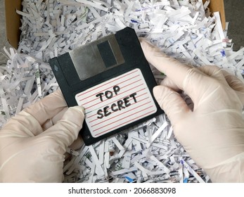 Top Secret Information On Retro Vintage Floppy Disk Magnetic Computer Among Shredder Paper, Thief Information Concept, Closeup