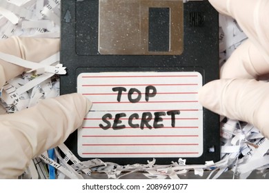 Top Secret Information On Retro Vintage Floppy Disk Magnetic Computer Among Shredder Paper, Thief Information Concept, Closeup