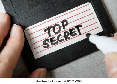 Top Secret Information On Retro Vintage Floppy Disk Magnetic Computer Among Shredder Paper, Thief Information Concept, Closeup