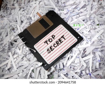 Top Secret Information On Retro Vintage Floppy Disk Magnetic Computer Among Shredder Paper, Thief Information Concept, Closeup