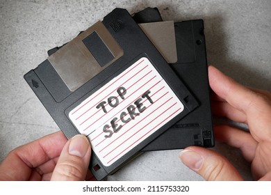 Top Secret Information On Retro Vintage Floppy Disk Magnetic Computer Among Shredder Paper, Thief Information Concept, Closeup