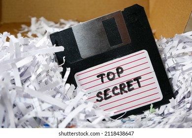 Top Secret Information On Retro Vintage Floppy Disk Magnetic Computer Among Shredder Paper, Thief Information Concept, Closeup