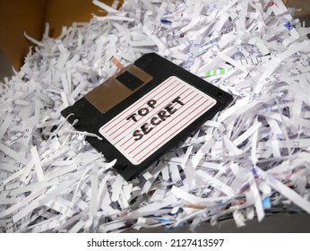 Top Secret Information On Retro Vintage Floppy Disk Magnetic Computer Among Shredder Paper, Thief Information Concept, Closeup