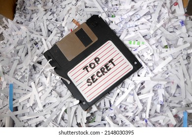 Top Secret Information On Retro Vintage Floppy Disk Magnetic Computer Among Shredder Paper, Thief Information Concept, Closeup