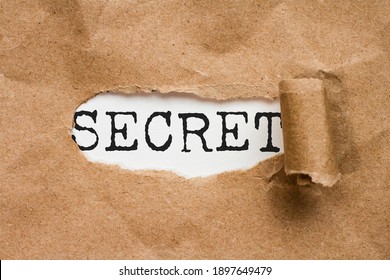 Top secret. The word secret discovered by the paper torn from a file - Shutterstock ID 1897649479