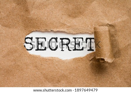 Top secret. The word secret discovered by the paper torn from a file