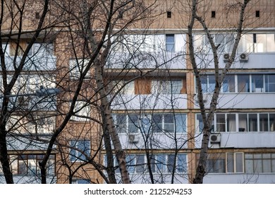 top section of a building and bare trees in front of it, urban scene