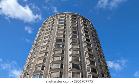 Top section of a modern cylindrical round building against clear blue sky