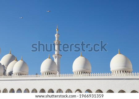 The top of Sheikh Zayed Mosque  with two helicopters cirlcling around for security, UAE, Abu Dhabi