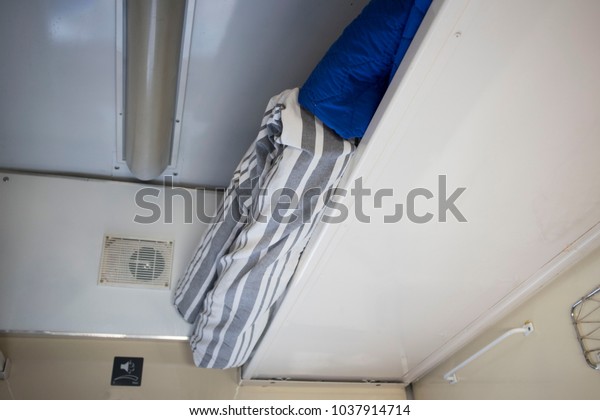 The top shelf in the second-class compartment of\
the train wagon with\
bedding