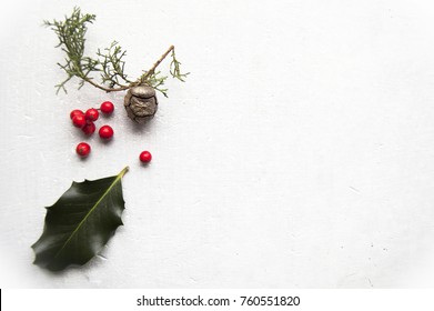 Top Shot, Close Up Of Red Christmas Berries  Branches, Holly, Ilex, Evergreen Cypress, Pine Cone  On Rustic, White  Table Background, Selective Focus, Space For Text