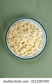 Top Shot Of Elbow Macaroni Noodles On A Green Background