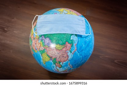 Top Shot Of A Globe Earth Map World Map With A Mask On It Corona Virus Covid-19 Concept Photo Global Pandemic